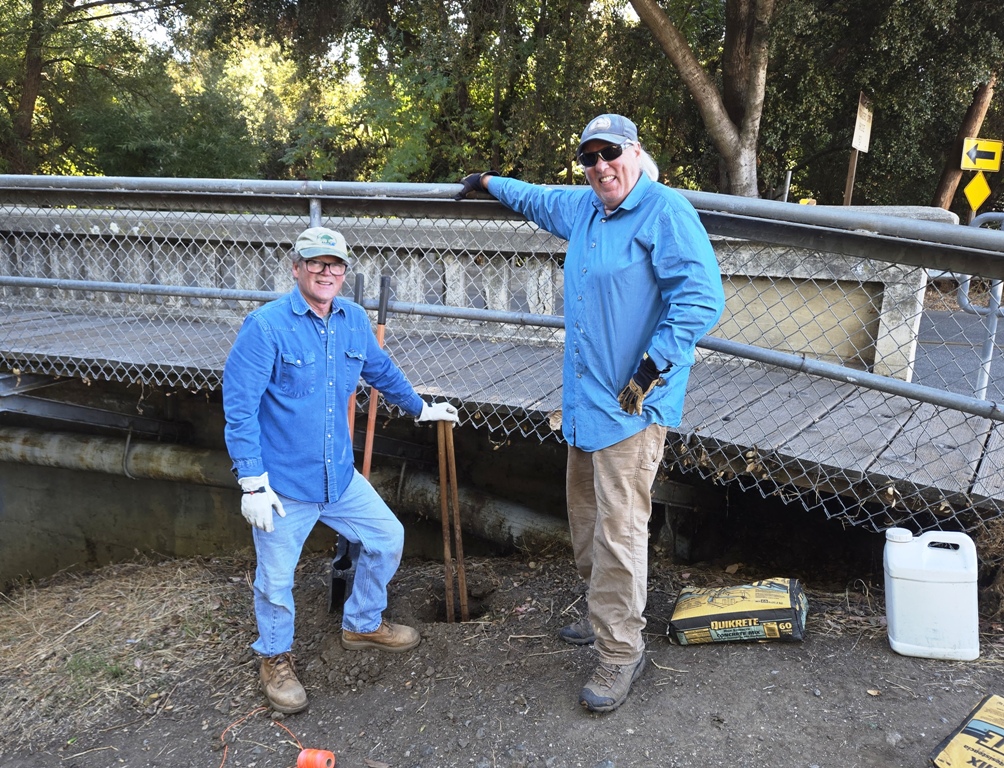 Jim and Dave digging a post hole.